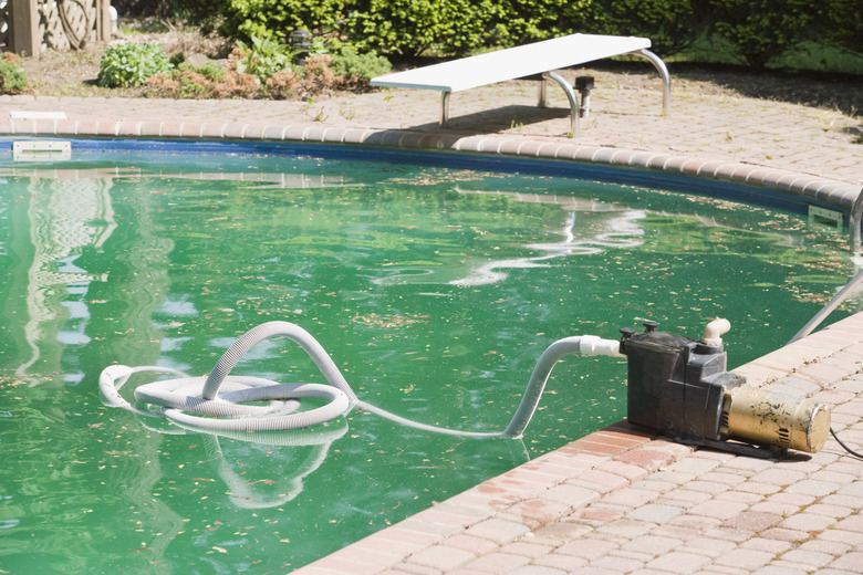 Swimming pool with cleaning device