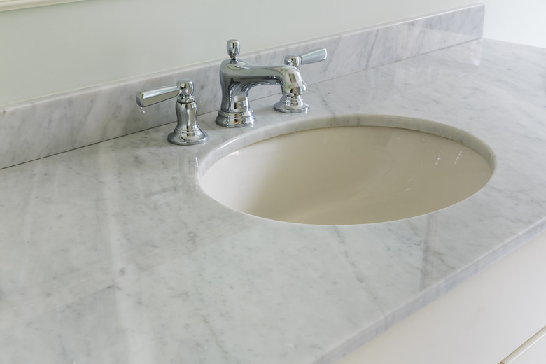 Light bathroom with marble counter top