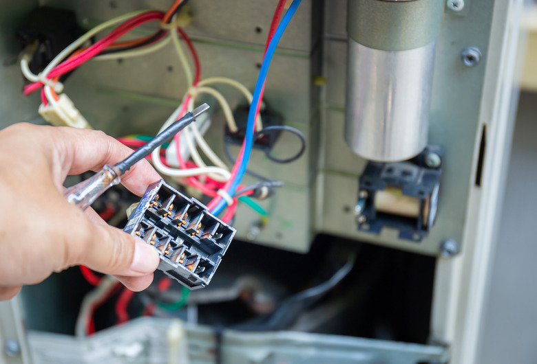 Close up of Air Conditioning Repair, repairman test, checking & repair of magnetic contactor and fixing air conditioning system