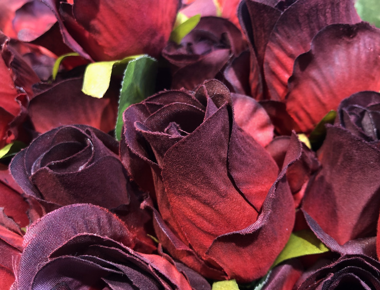 Deep red cloth roses background.