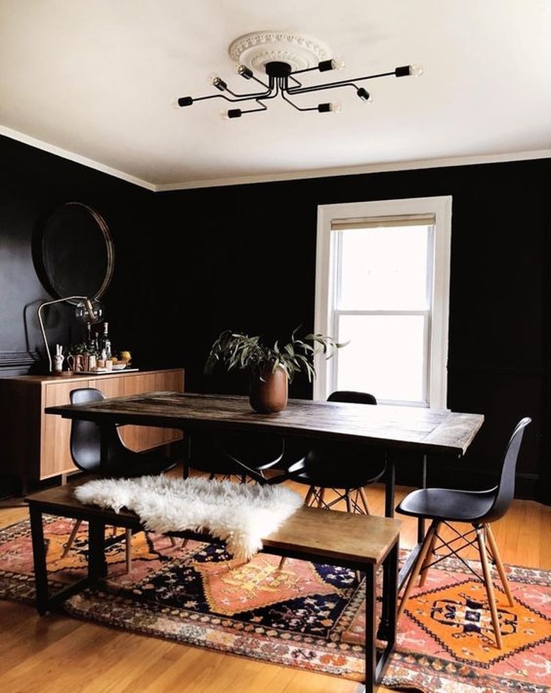 black dining room color idea with bright rug