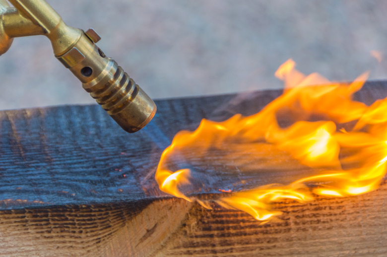 fire from a gas burner treated lumber