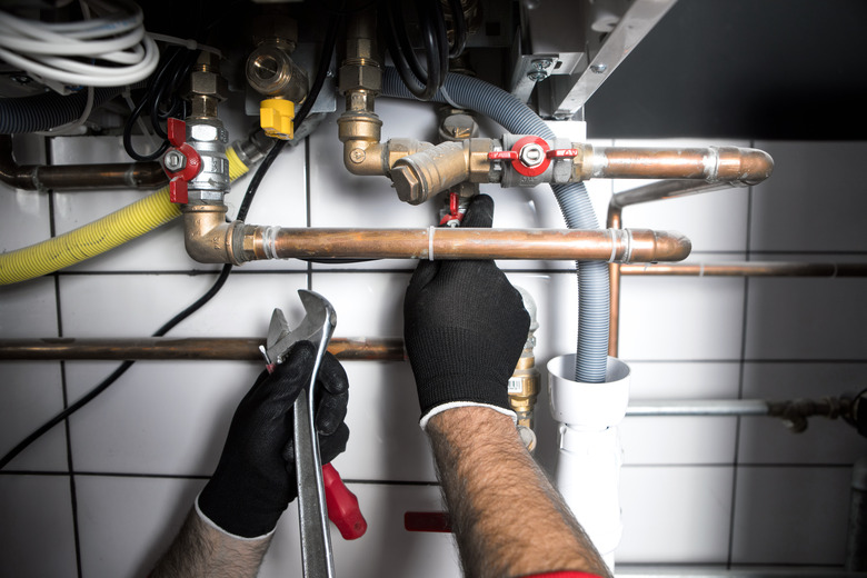 Plumber working with a wrench.