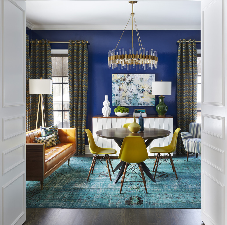 room with blue wall and teal rug