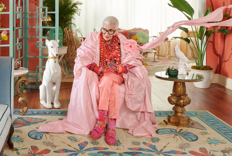 Iris Apfel in a colorful living room with her new rug design with Ruggable