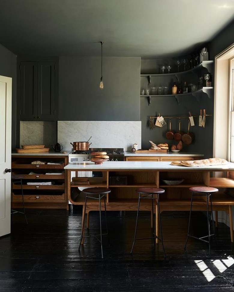 unfinished oak cabinets in kitchen with dark green walls and ceiling