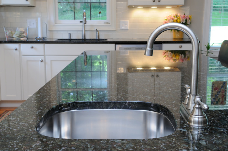 Kitchen sink on granite counter.