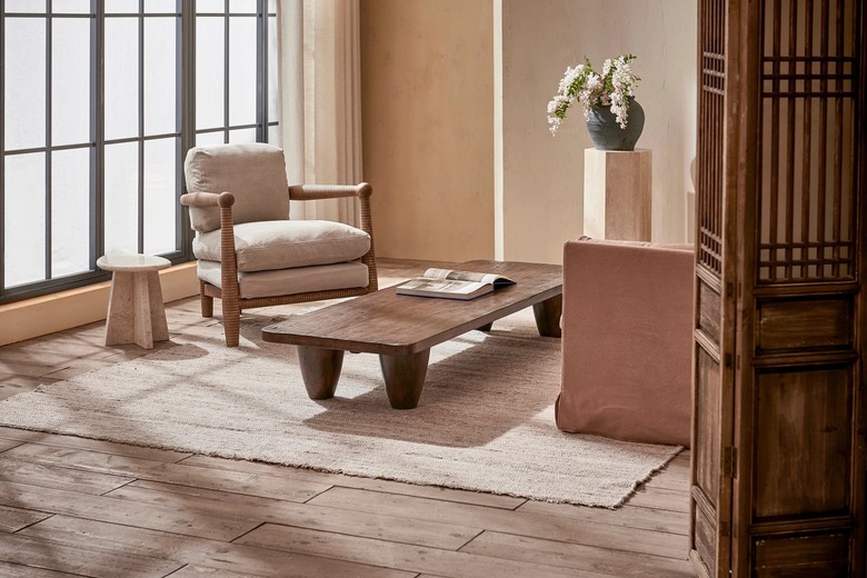 neutral living room with chair and coffee table