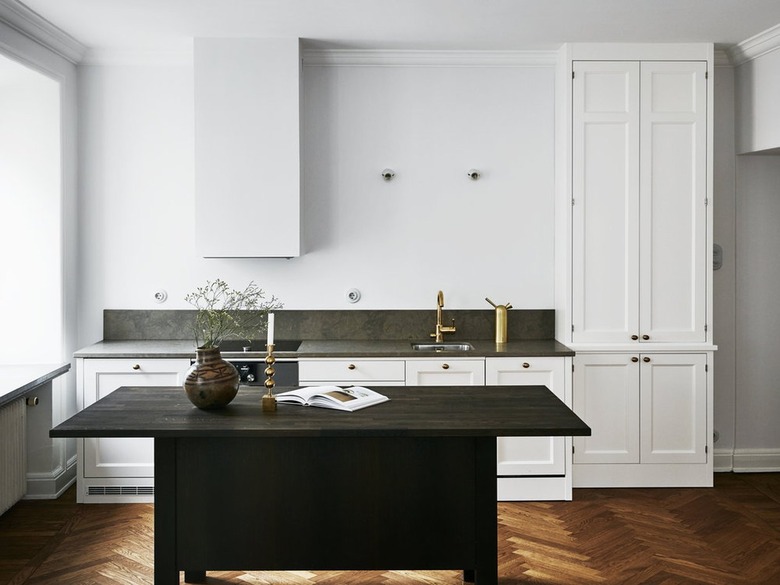 white kitchen cabinets with dark green countertop