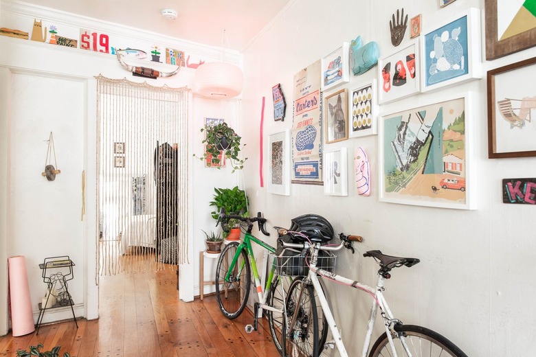 Hallway Lighting Ideas in Apartment hallway with artwork and bikes leaning on them