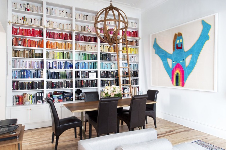 Rainbow bookshelves with artwork by Caroline Wells-Chandler