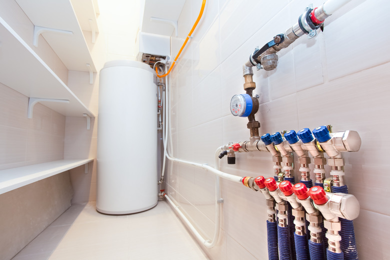 Copper valves, stainless ball valves and plastic pipes on a boiler room equipment in apartment during under renovation, remodeling and construction.