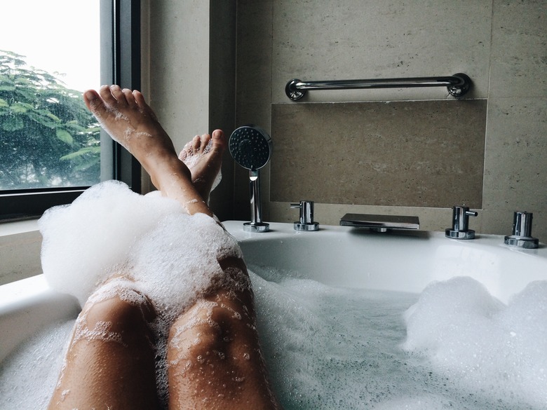 Low Section Of Woman Bathing In Bathtub