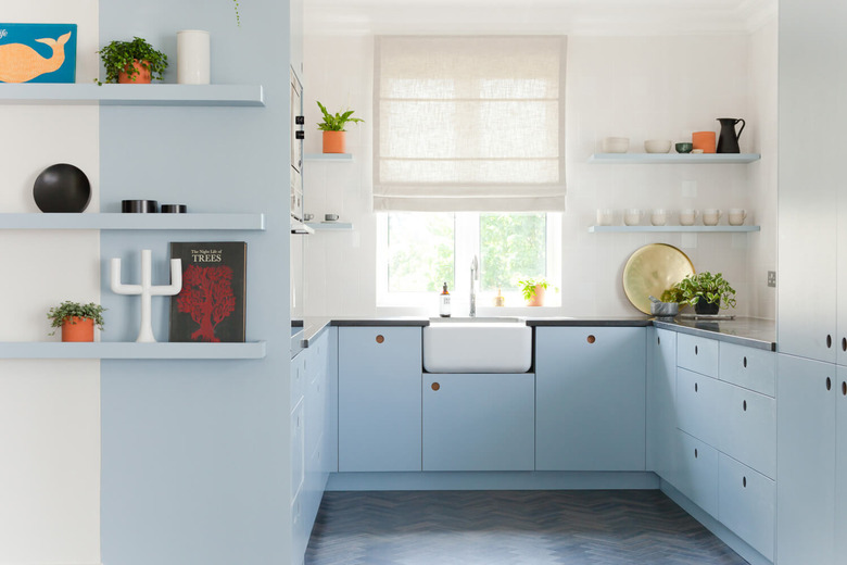 blue and white kitchen with open shelving and farmhouse sink