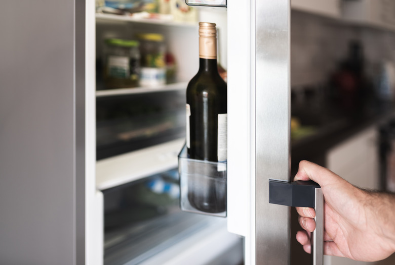 Cropped Hand Holding Refrigerator Door