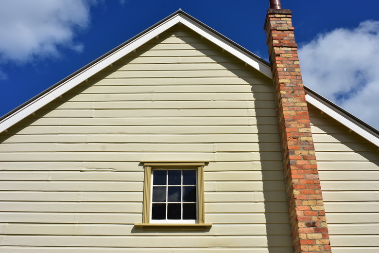 Vintage Wooden House With Brick Chimney