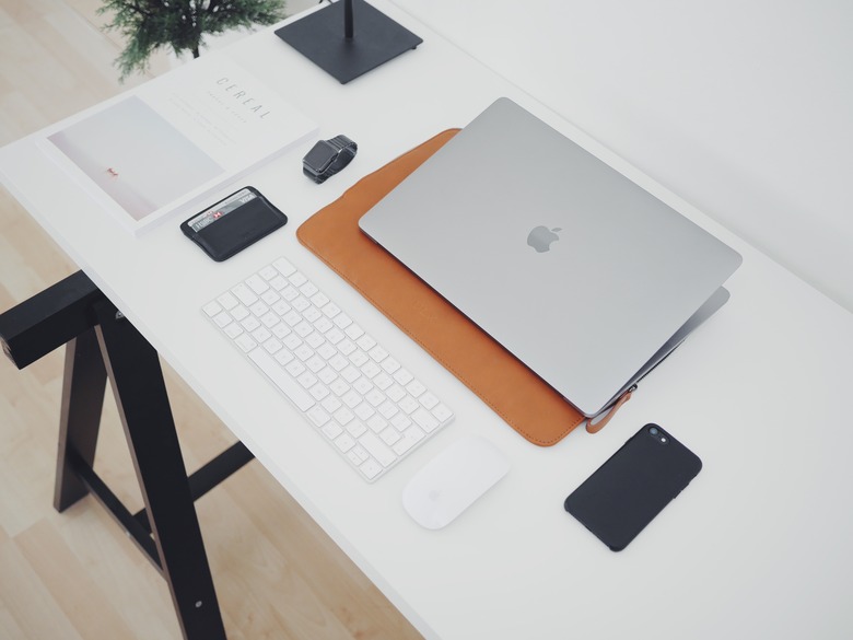 desk with computer, keyboard, phone and other desk tools