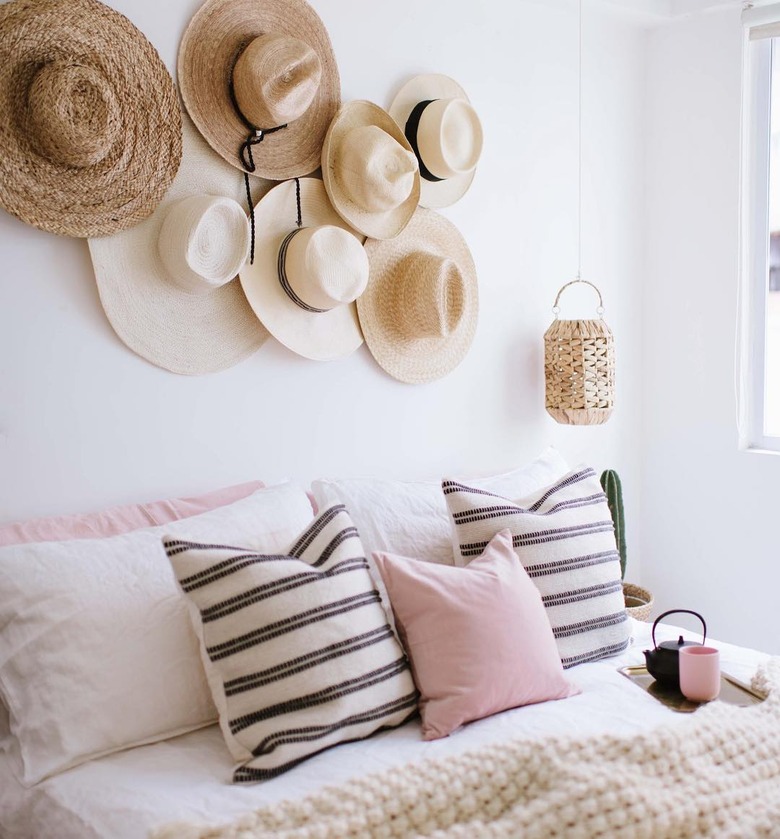 gallery wall made of hats on bedroom wall