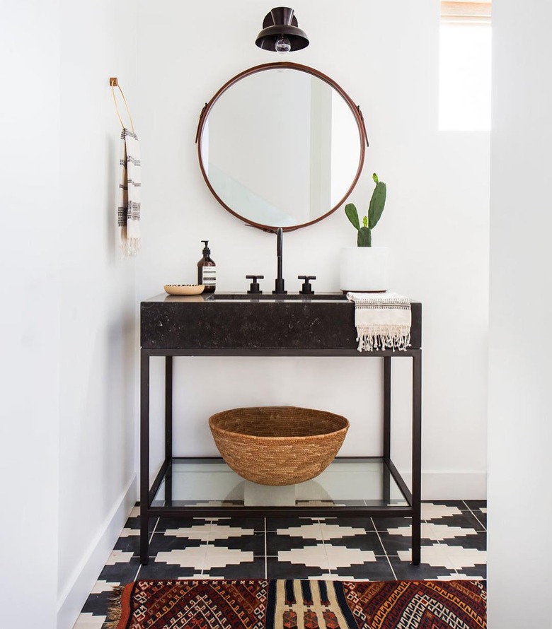 Bathroom organization idea with shelf under console sink and patterned floor tile