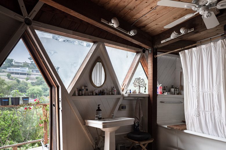 triangular bathroom windows above pedestal sink