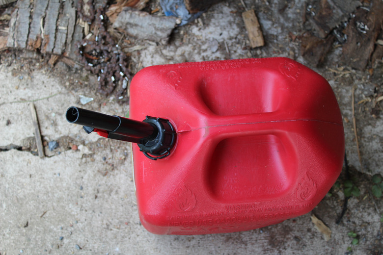 Plastic Gas Can on dirty shop floor