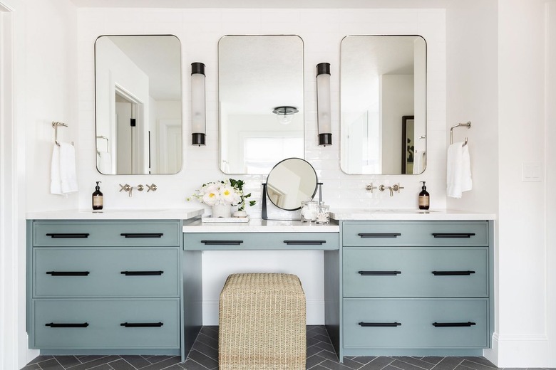 bathroom with white walls and sage green vanity