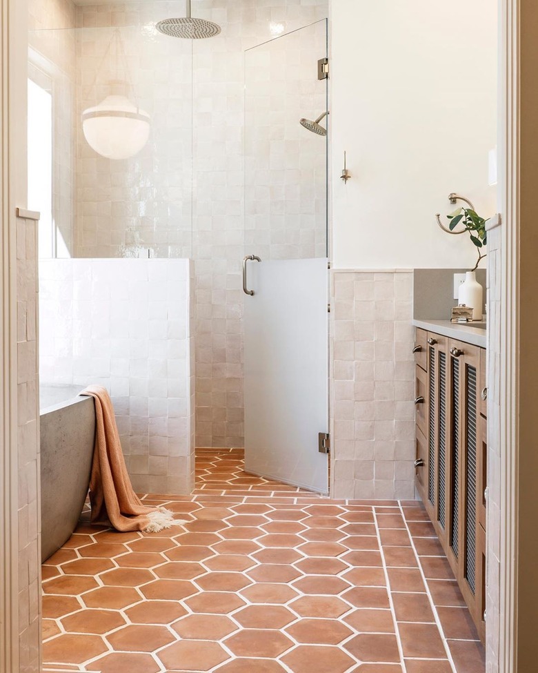 contemporary shower with terra cotta floors and glass shower door