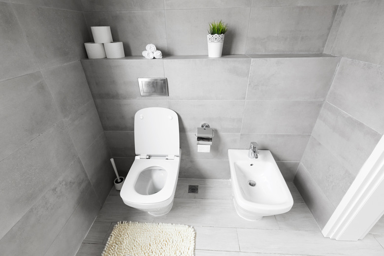 White ceramic bidet and toilet at luxury bathroom