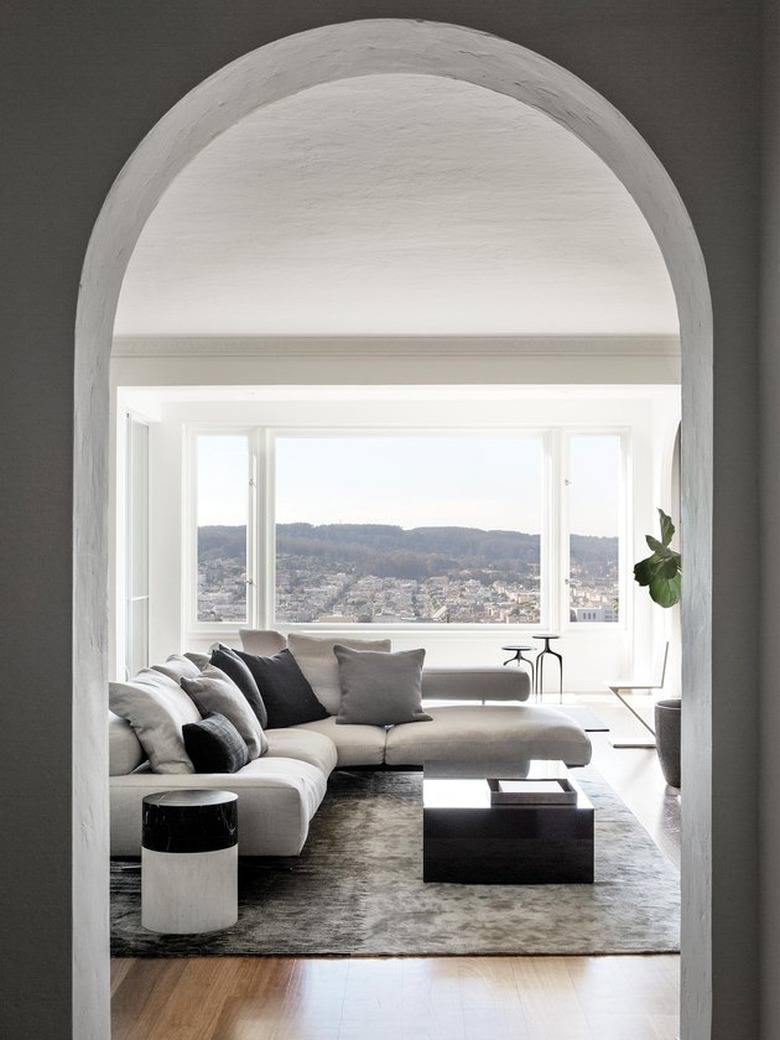 arched doorway leading to neutral living room with view of san francisco