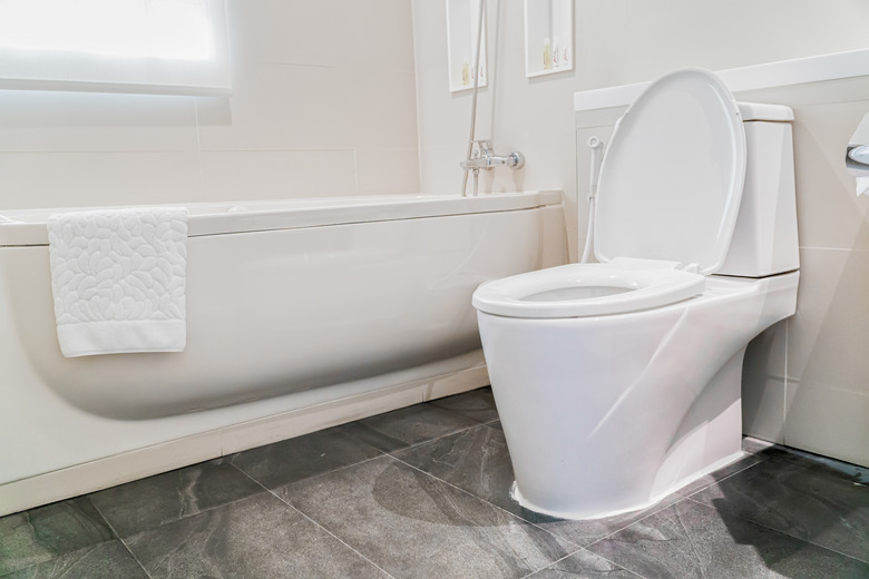 White tub and toilet in bathroom.