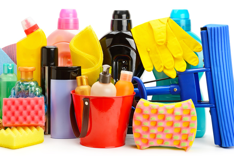 Collection of various household cleaning products isolated on a white background.