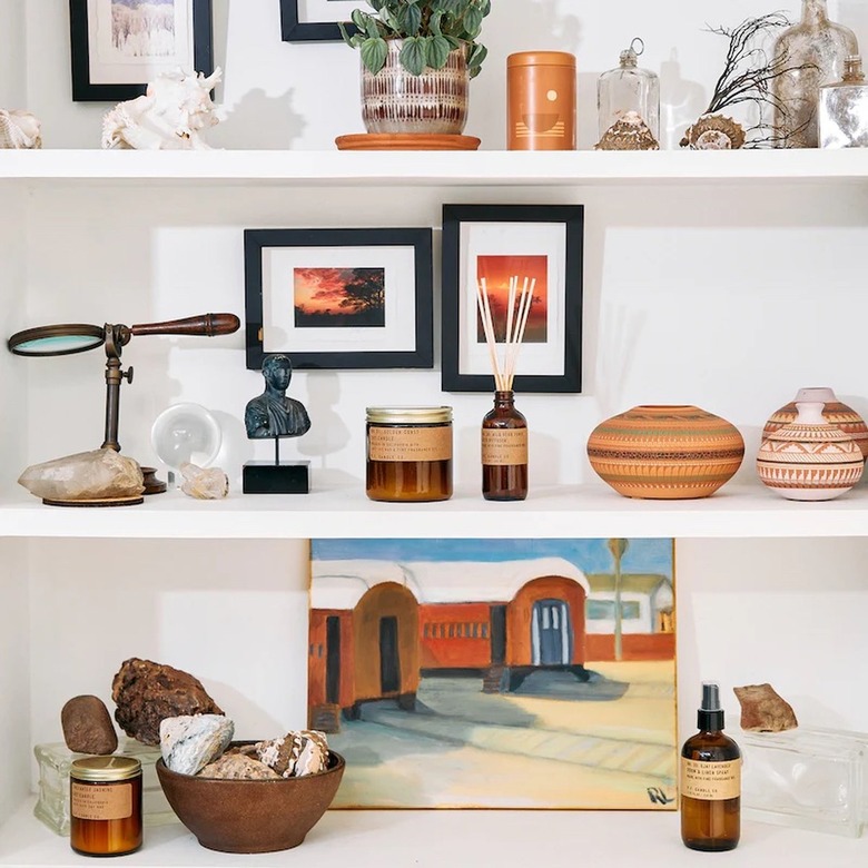 shelf with candles and diffusers and knickknacks