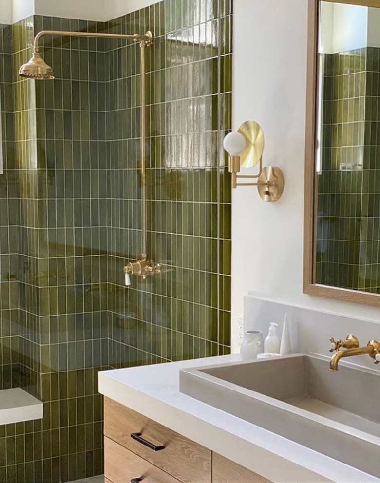 brass shower fixtures with vertically stacked green tile