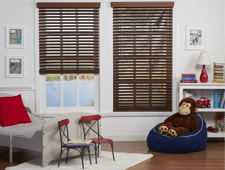 Horizontal faux wood blinds on windows in child