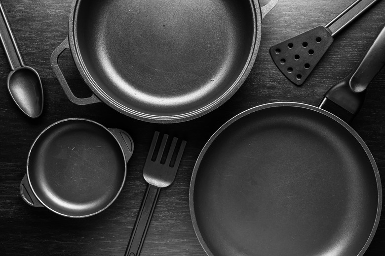 Black cookware with a nonstick coating on black background