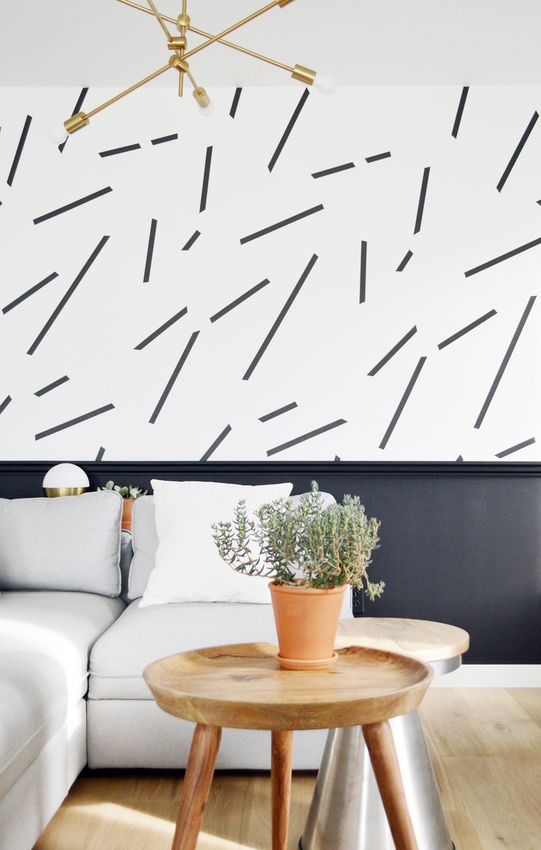 black-and-white living room idea with wainscoting and patterned wallpaper