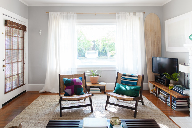 living room with two chairs in front of open window with sheer drapery