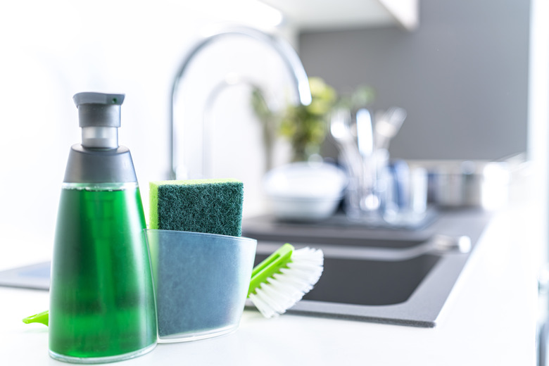 Bottle of dishwashing liquid on kitchen counter.