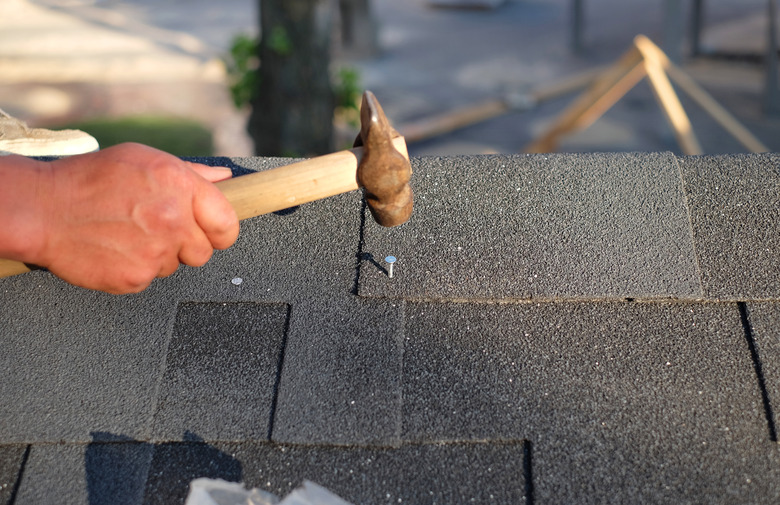 Contractor nailing shingles.