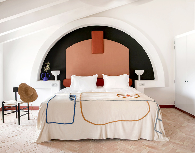 white room with terra cotta color headboard