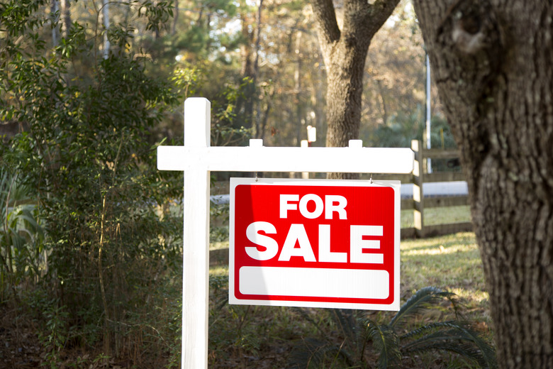 Home for sale with real estate sign. Front Yard.