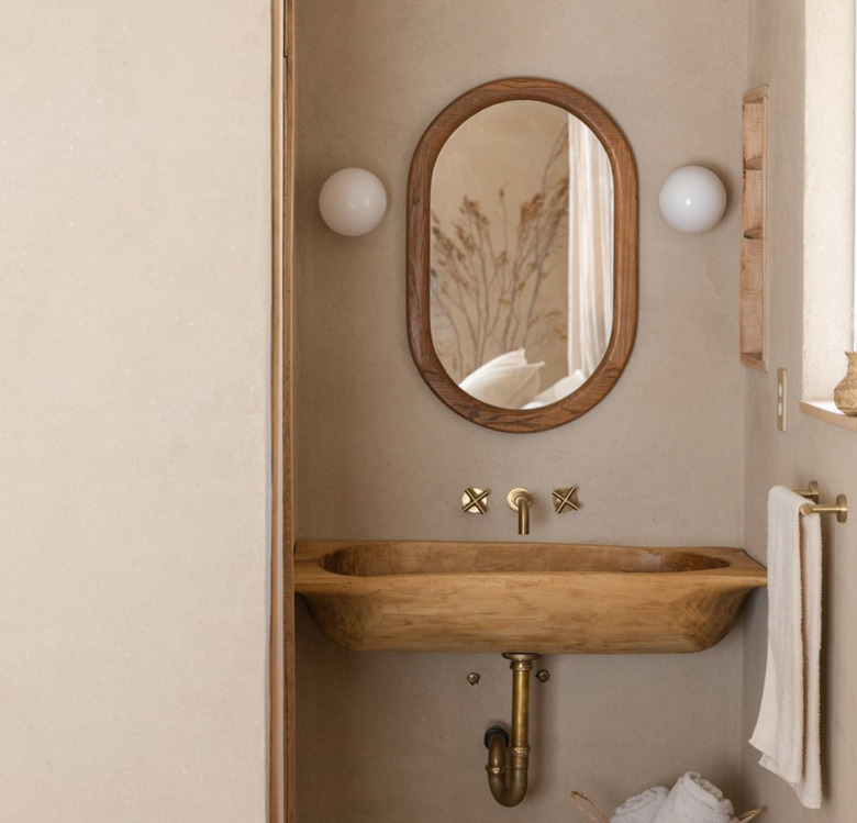 Wood sink, brass Wall-Mounted Bathroom Faucet, oval mirror, vanity lights.