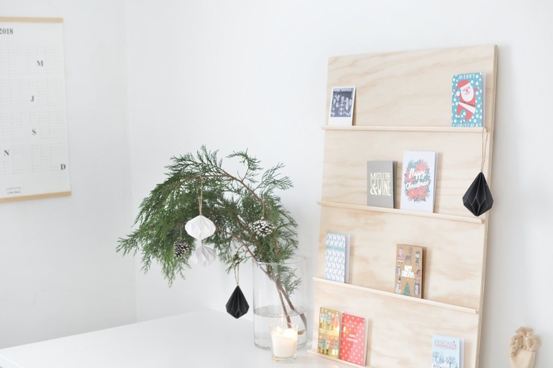 holiday cards sit on shelves made from thin strips of moulding glued to a plywood sheet