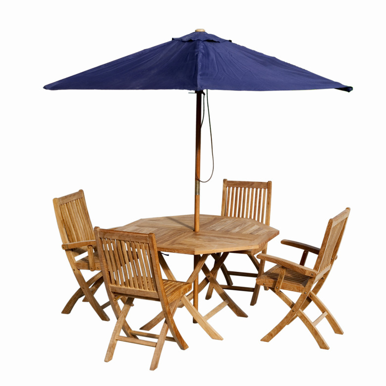 Close up of a garden table and chairs and an umbrella