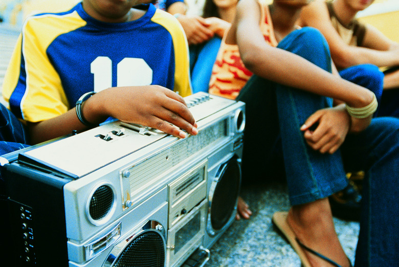 close-up of a stereo with people sitting around