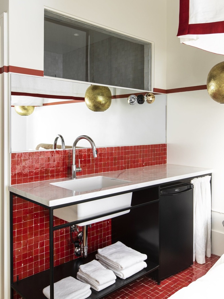 red color blocked bathroom with gold accents