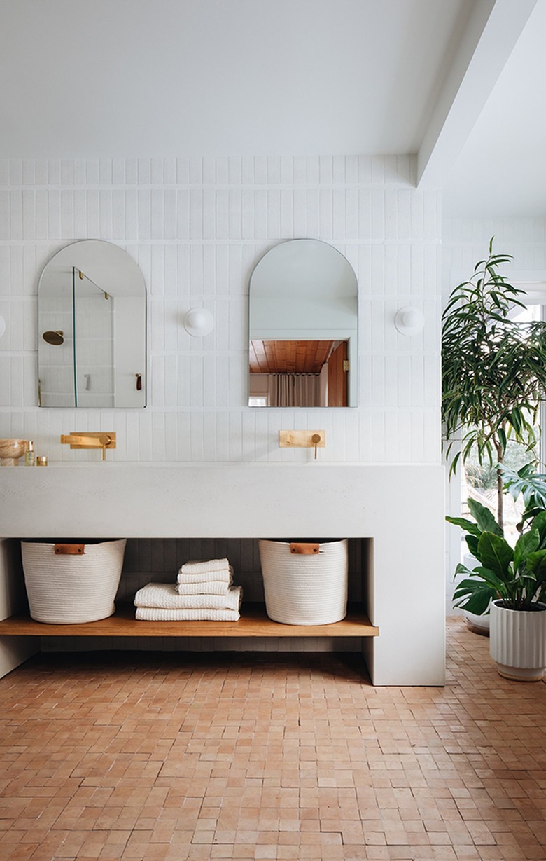 white bathroom with terracotta tile floor