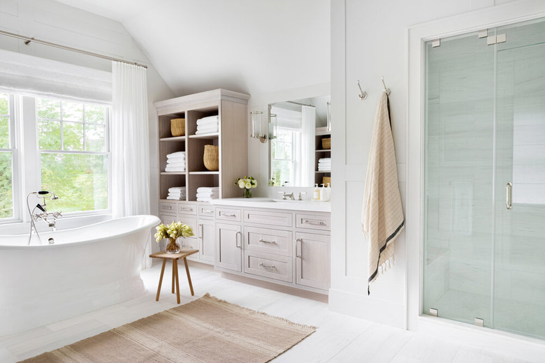 Modern bathroom storage with a freestanding tub, drawers and hutch by Chango & Co.