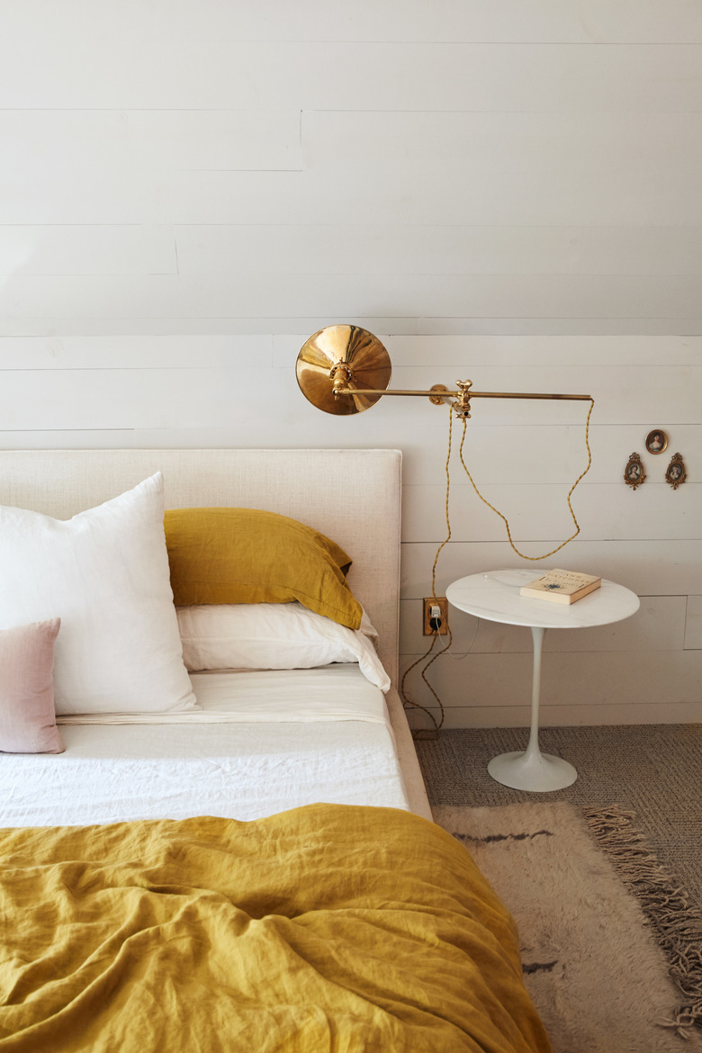 Brass wall-mounted light modern bedroom lighting idea