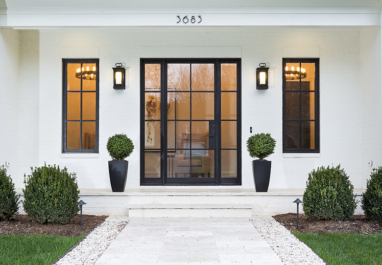 modern exterior door on white house with black steel frame